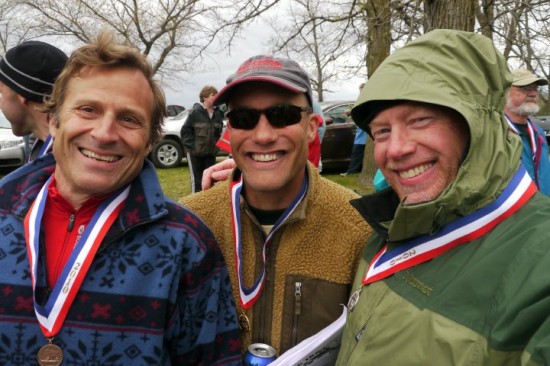 John in center sharing a laugh after a race with friends.